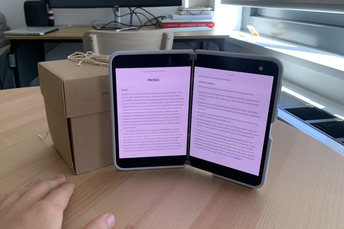 An Amazon Kindle book open across the two screens of the Surface Duo, so that the two pages open like a book